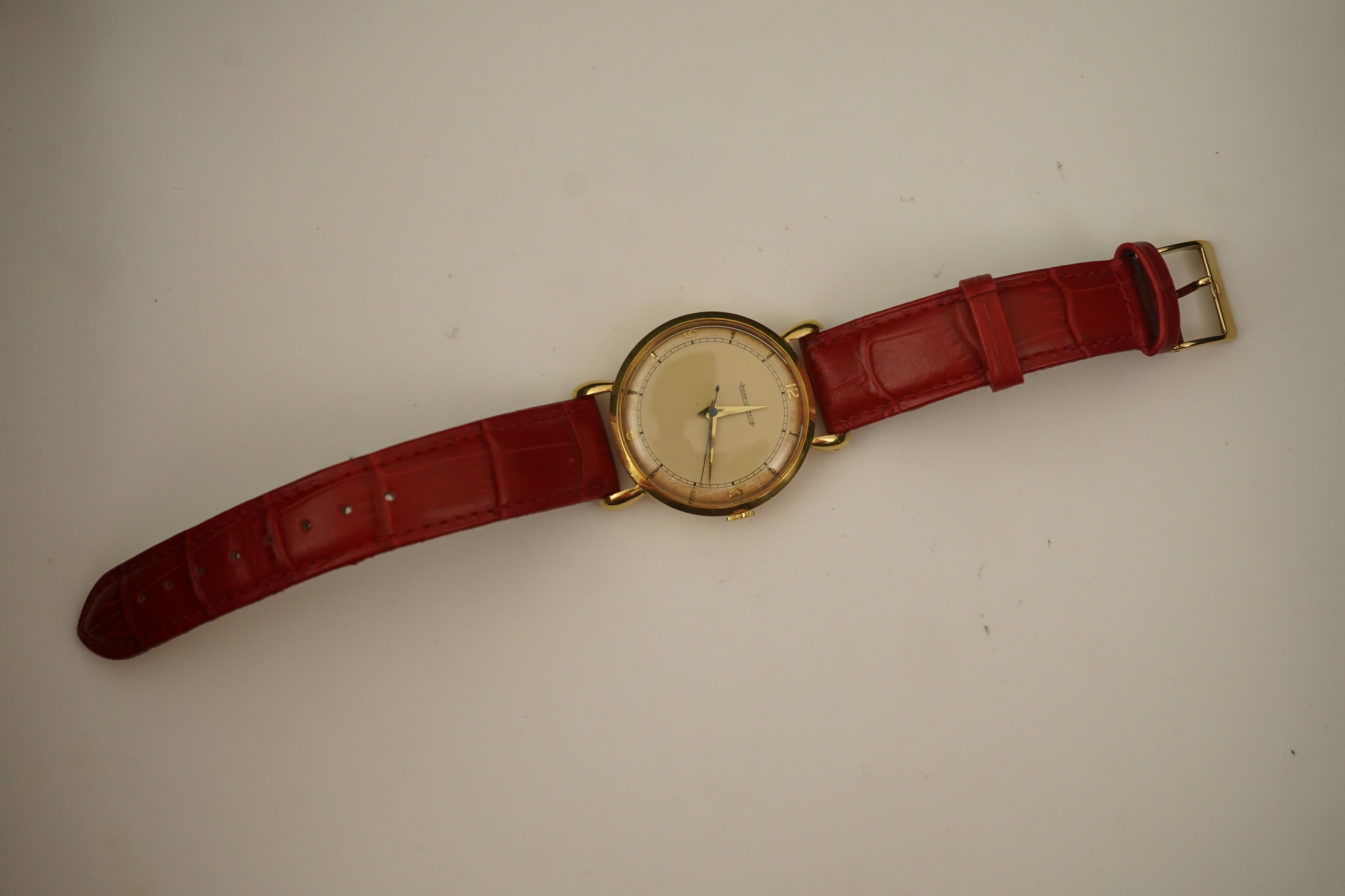 A gentleman's 1950's 18ct gold Jaeger LeCoultre manual wind wrist watch, on a later associated leather strap